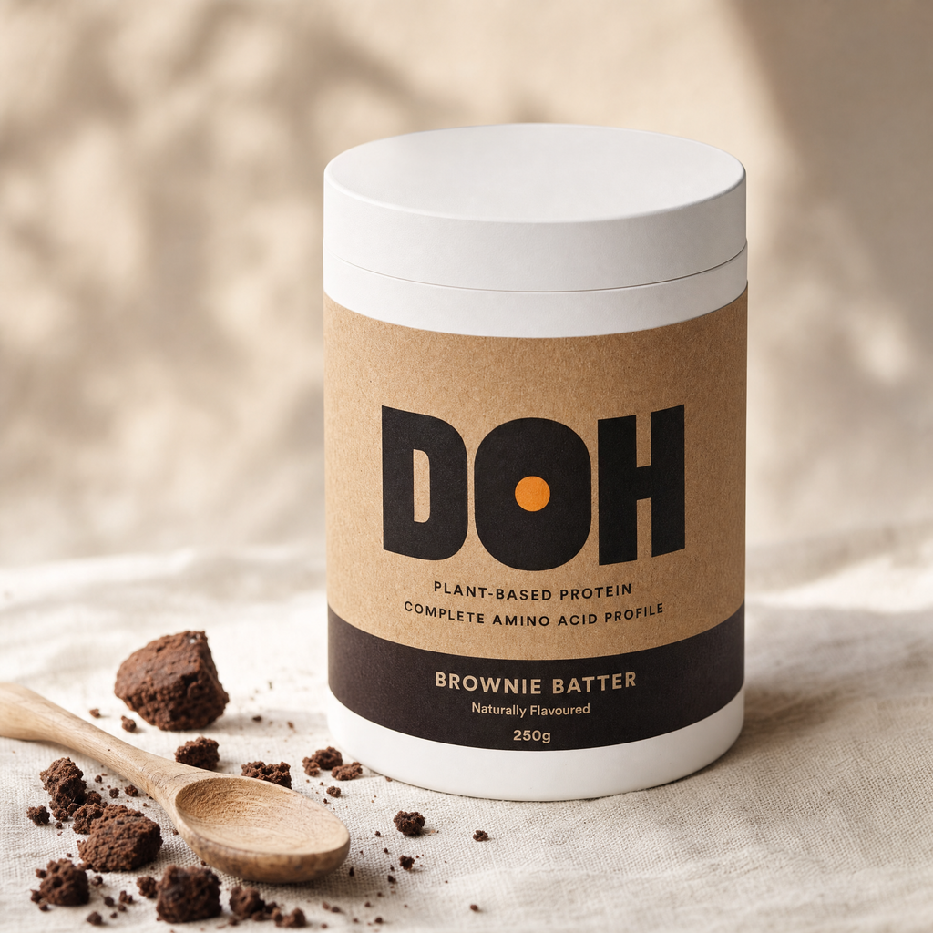 DOH Snacking Dough — Brownie Batter tub with espresso-black band, scattered brownie crumbles