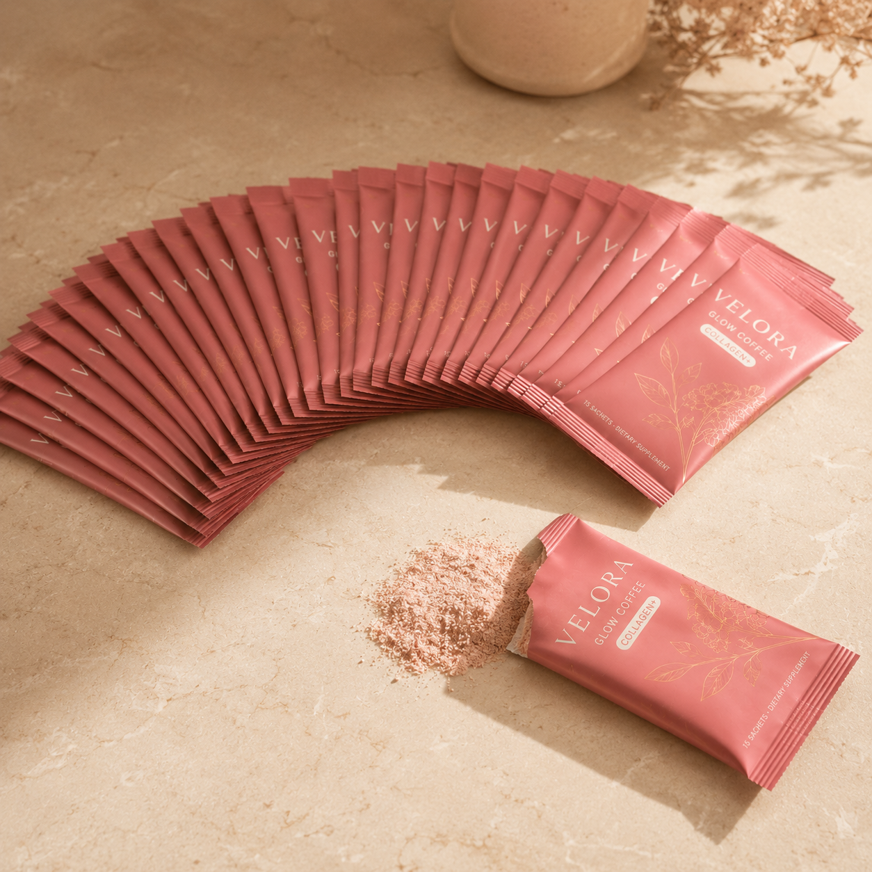 Velora Glow Coffee 30 sachets fanned out with one open showing pink powder